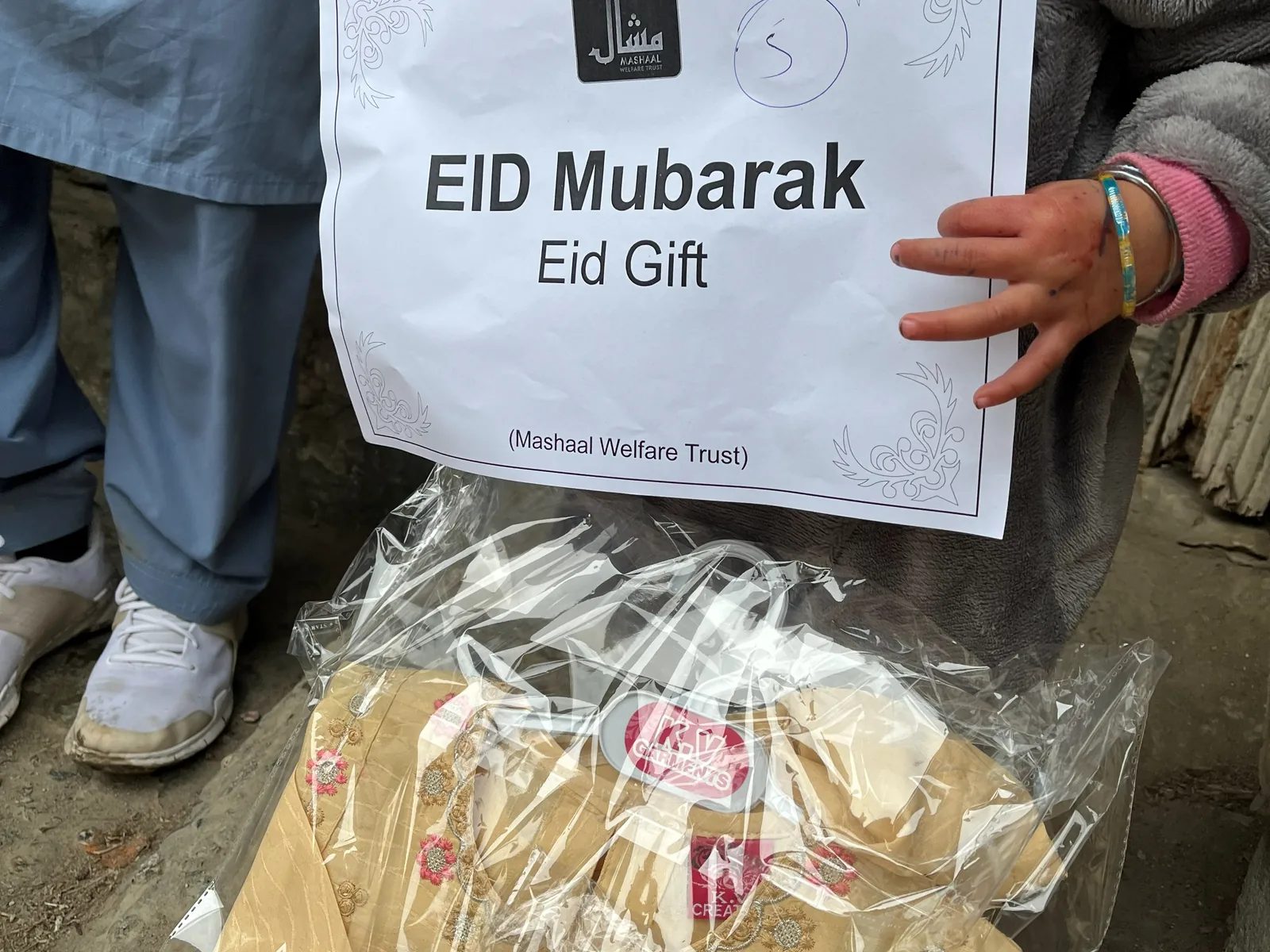 An Eid parcel of new clothes, labelled Eid Mubarak, Eid Gift, from Mashaal Welfare Trust.