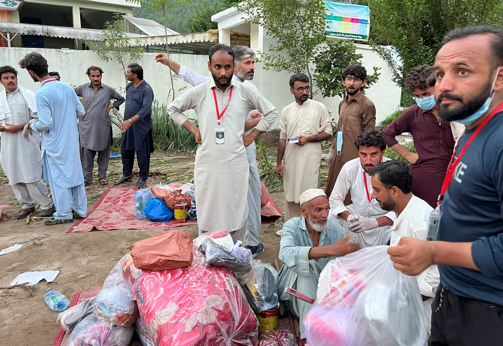 A distribution under way, packages laid out and handed over one by one.
